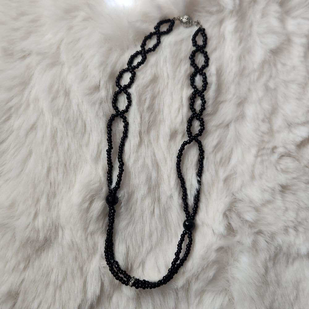 Handmade black beaded necklace with silver crystal detail and silver ball charm